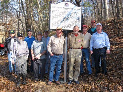 members of 2034 by the Rials-Sullivan Cemetery Sign