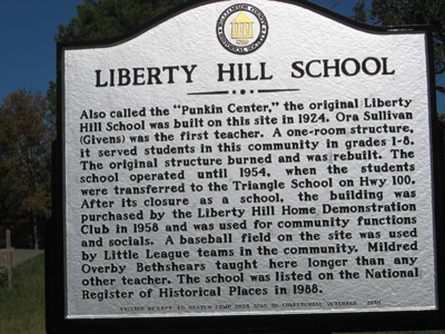 members of 2034 by the Rials-Sullivan Cemetery Sign