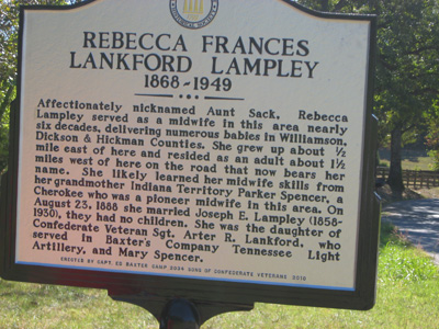 members of 2034 by the Rials-Sullivan Cemetery Sign