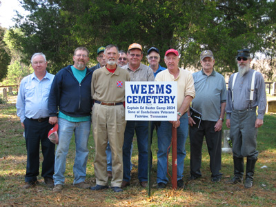 members of 2034 by the Rials-Sullivan Cemetery Sign