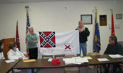 Picture of Renee Bowser presenting the hand sewn replica of the Baxter Memorial Flag.